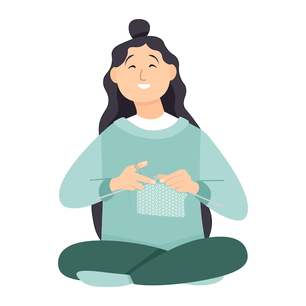 Cute young woman knitting while sitting in lotus position