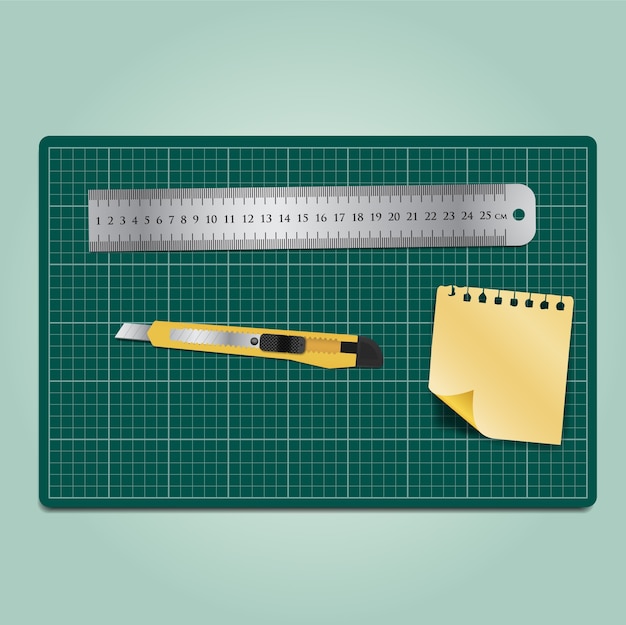 Vector cutter ruler and paper on the green cutting mat