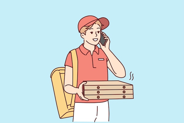 Deliveryman with pizza boxes calling client