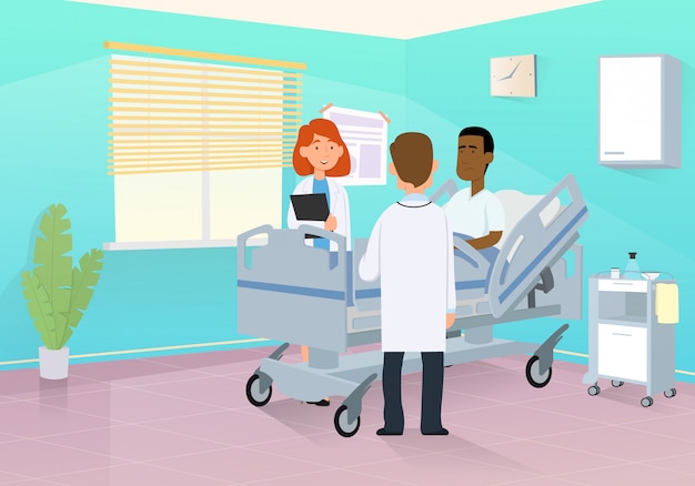 Doctor visits a patient in a hospital room.