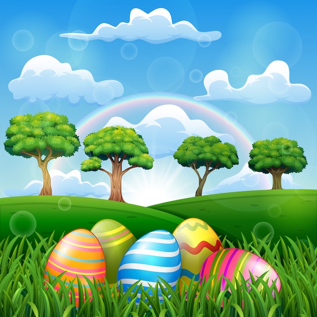 Uovo di pasqua sul campo in erba con uno sfondo arcobaleno