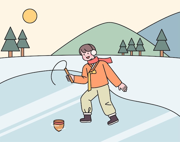Een jongen die in de koude winter een hanbok draagt, speelt topjes op het ijs