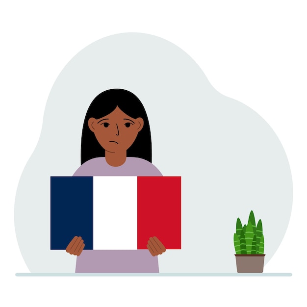 Een klein meisje houdt de vlag van Frankrijk in zijn handen Het concept demonstratie nationale feestdag of patriottisme Nationaliteit