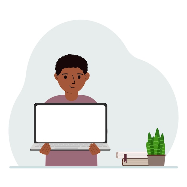 Een kleine jongen houdt een laptop in zijn handen Het concept van online leren blijf thuis thuisonderwijs