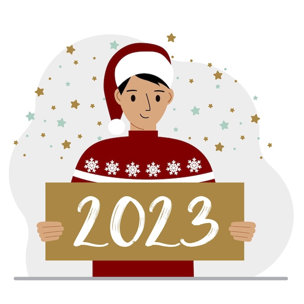 Een man in een rode trui en met een pet houdt een bord of poster vast met de nummers 2023 ansichtkaart of groet prettige kerstdagen en een gelukkig nieuwjaar