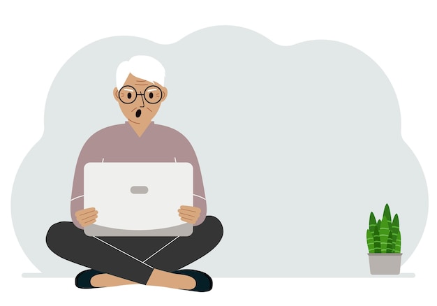 Een man zit met gekruiste benen in zijn handen en houdt een laptop vast Het concept van werkonderwijs, het lezen van video's