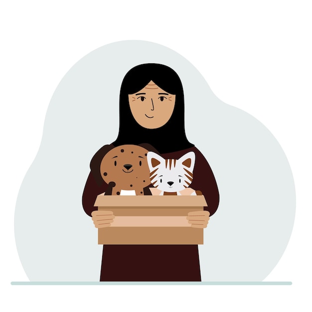 Een vrouw houdt een kartonnen doos vast met een kat en een hond Het concept van reddingshulp en zorg voor huisdieren