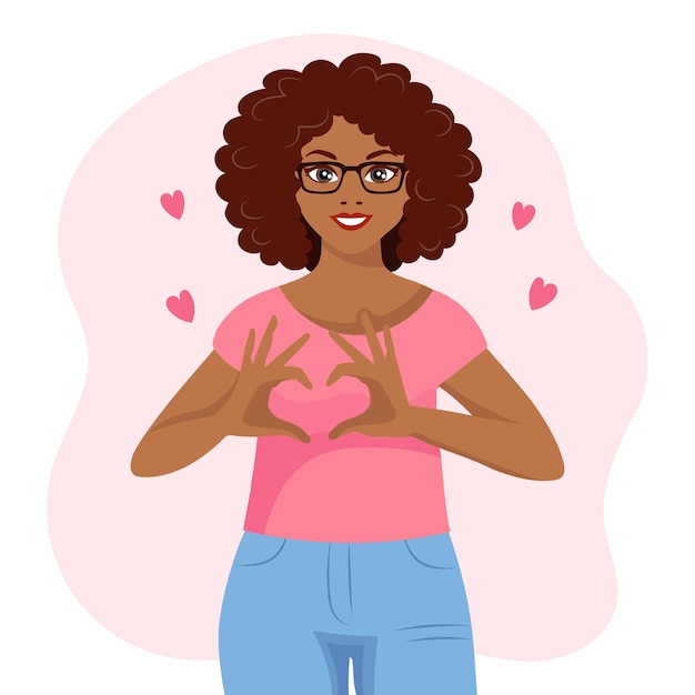 Een zwarte Afro-Amerikaanse vrouw met een vrolijke uitdrukking toont een hart met haar handen. Menselijke emoties