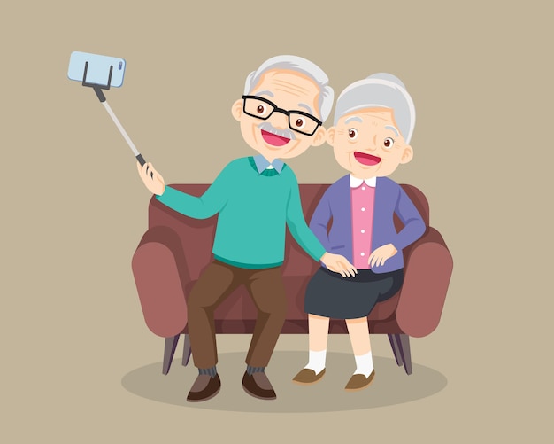 Elderly couple seat on sofa and making photo together on mobile phone with selfie stick