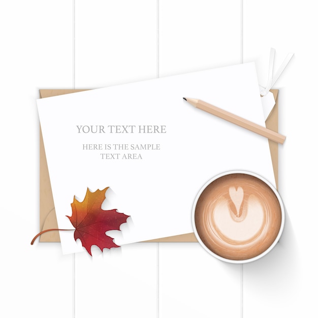 Elegant paper with maple leaf and coffee on wooden background