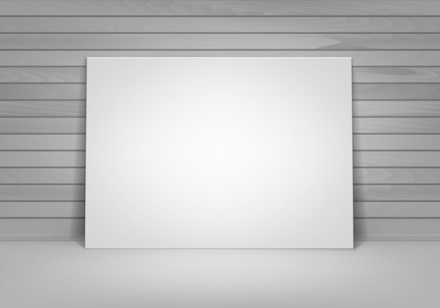 Empty blank white mock up poster picture frame standing on floor with wooden wall front view