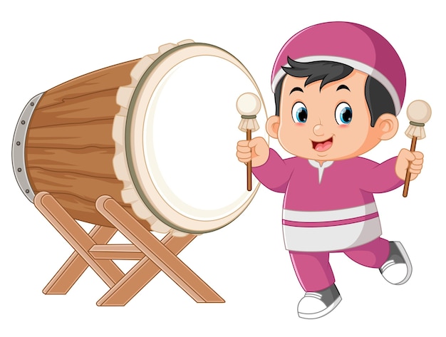 An excited Muslim boy beating a big drum