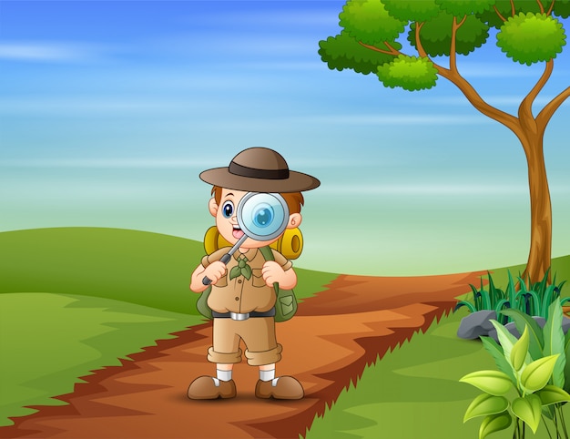 The explorer boy with magnifying glass on the road