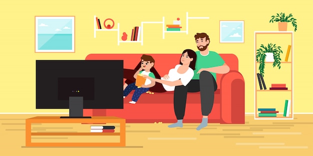 Familie die op TV letten en thuis popcorn eten
