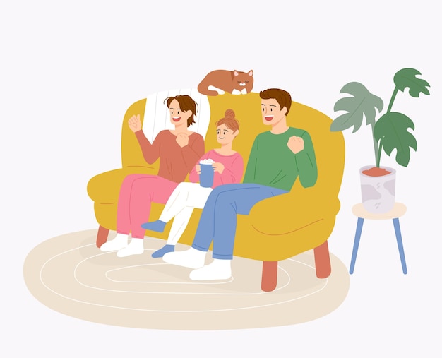 The family is sitting on the sofa together and watching tv having fun