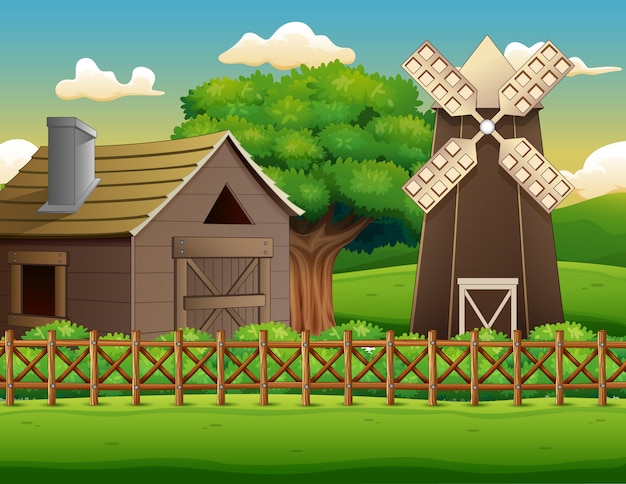 倉庫と風車のある農場風景