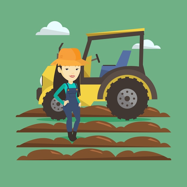 Farmer standing with tractor on background.