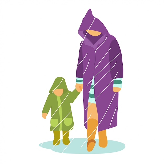 Un padre con un bambino piccolo che gioca nel bel mezzo della stagione delle piogge con indosso un cappotto