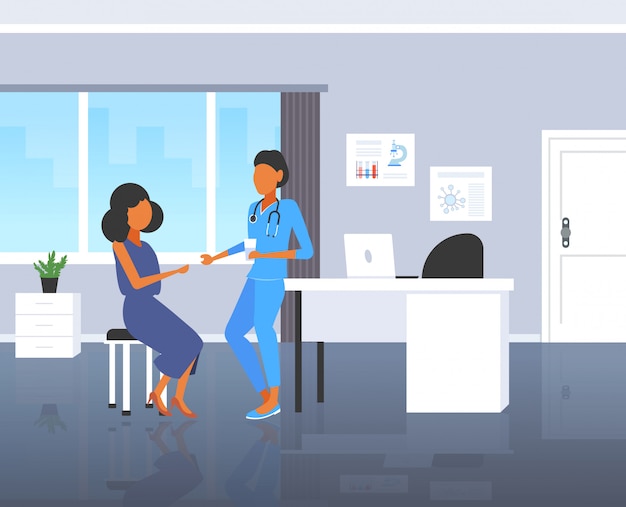 Female doctor giving pill and glass of water to woman patient pharmacist offering pills medication healthcare concept modern hospital room interior full length