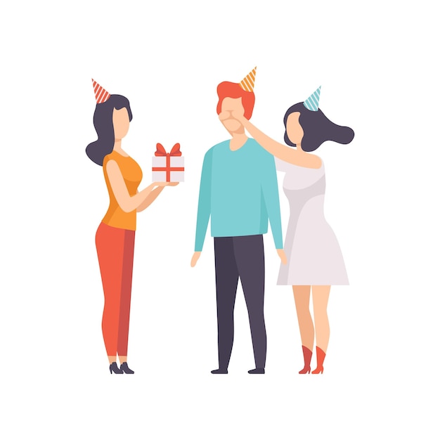 Vector female friends giving gift box decorated with red ribbon bow to young man in party hat people celebrating the holiday congratulations to a friend vector illustration isolated on a white background