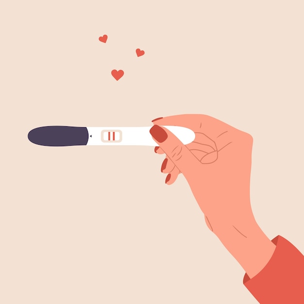 Female hand is holding positive pregnancy or ovulation test