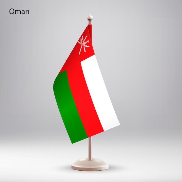 Flag of Oman hanging on a flag stand