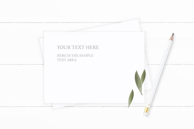 Flat lay top view elegant white composition paper nature leaf and pencil on wooden background.