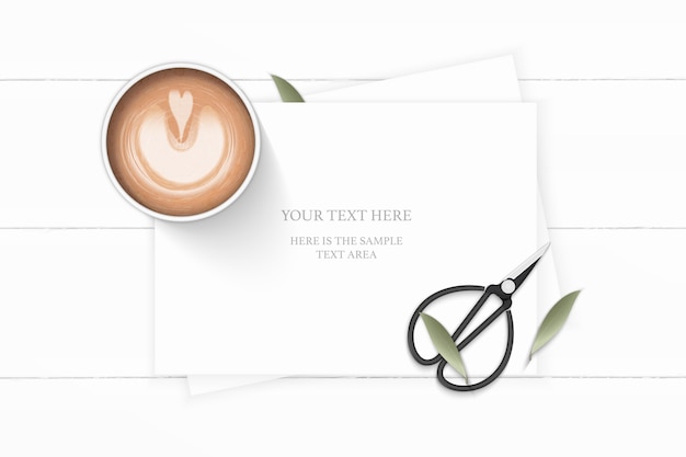 Vector flat lay top view elegant white composition paper plant leaf coffee and vintage metal scissors on wooden background.