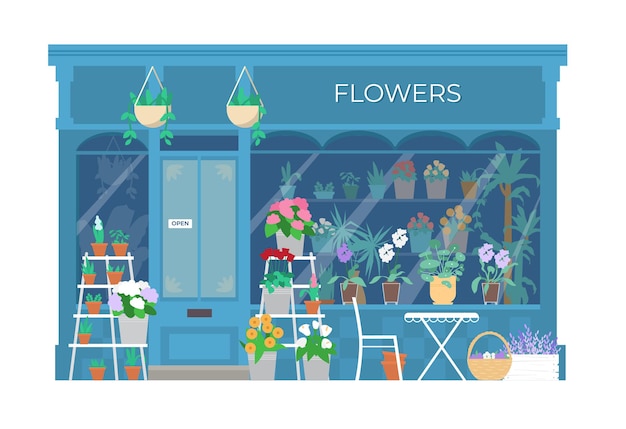 Витрина здания цветочного магазина с растениями и цветами в ведрах и горшках