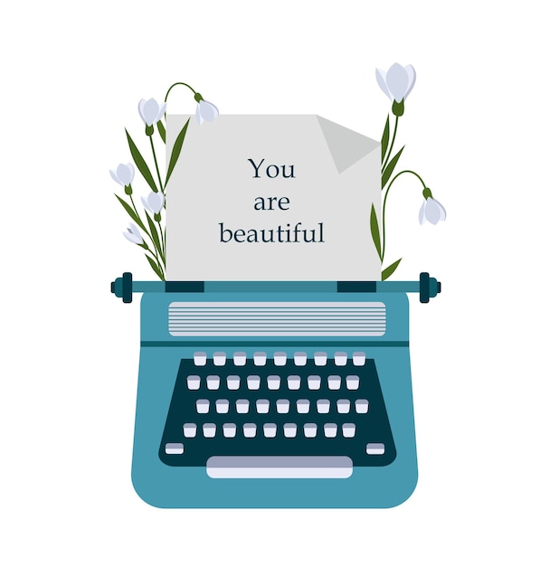 Flowers snowdrops around a vintage typewriter with a inscription you are beautiful