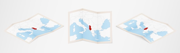 Folded map of albania in three different versions.