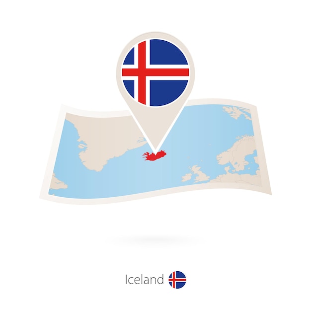 Folded paper map of iceland with flag pin of iceland