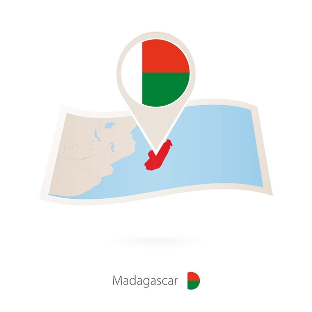 Folded paper map of Madagascar with flag pin of Madagascar