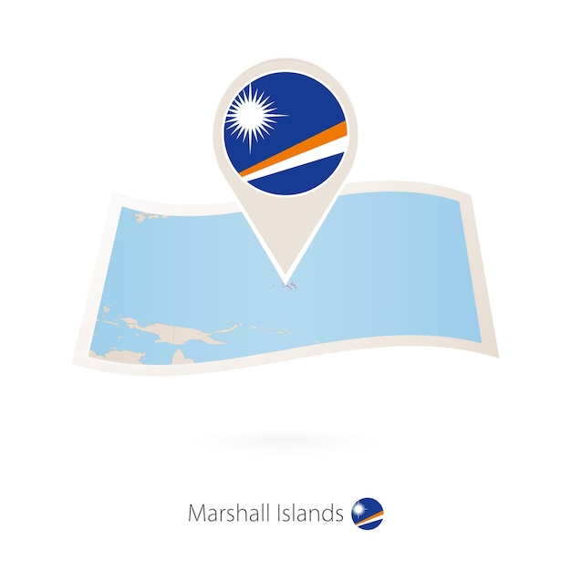 Folded paper map of Marshall Islands with flag pin of Marshall Islands