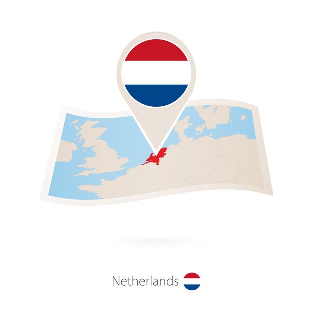 Folded paper map of Netherlands with flag pin of Netherlands