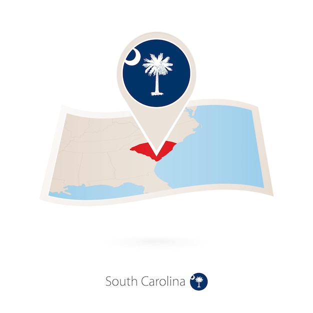 Folded paper map of South Carolina US State with flag pin of South Carolina