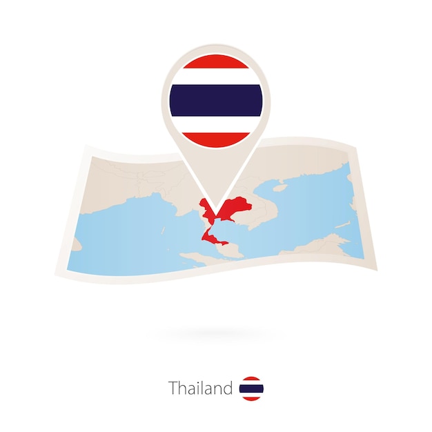 Folded paper map of Thailand with flag pin of Thailand