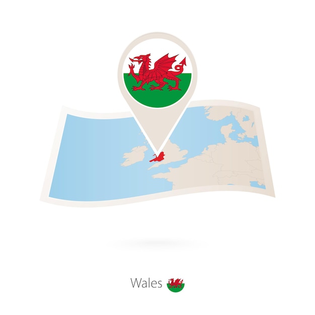 Folded paper map of Wales with flag pin of Wales