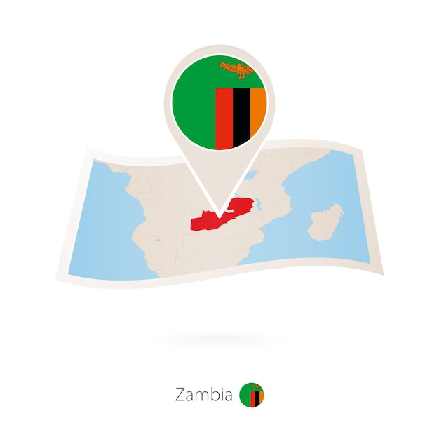 Folded paper map of Zambia with flag pin of Zambia