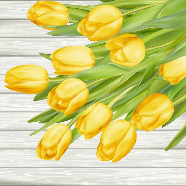 Fresh yellow tulips on wooden background.