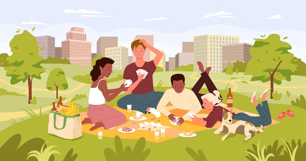 Friends people on picnic party in summer city park landscape playing card game drinking