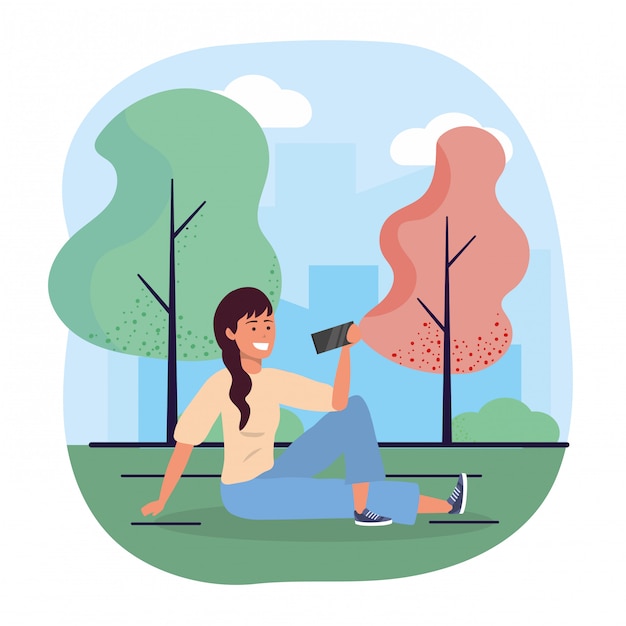 Fun woman seating with smartphone and trees