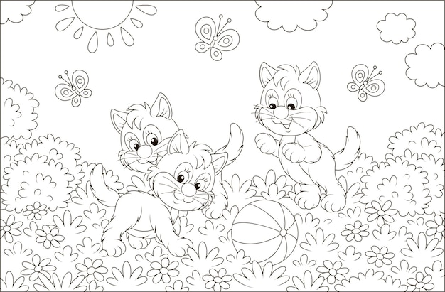 Funny little kittens playing with a ball and butterflies on grass among flowers on a sunny day