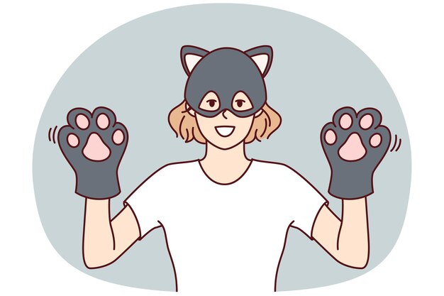 고양이 마스크를 입은 재미있는 여성은 고양이 발바닥의 형태로 장갑을 착용한 손을 보여줍니다. 터 이미지