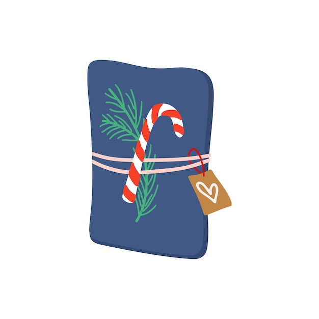 Gift box packaged with blue paper, string, candy cane, pine and label. Winter holiday present.