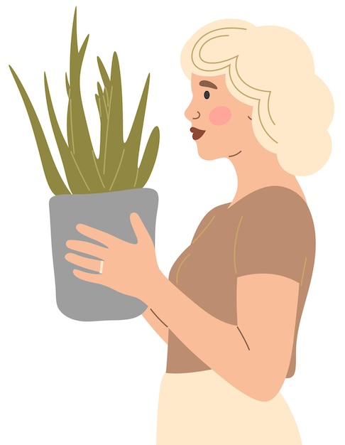 La ragazza tiene tra le mani una pianta in vaso