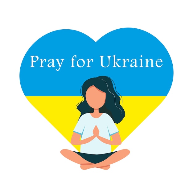 A girl prays for peace in Ukraine against the background of the heart and flag of Ukraine