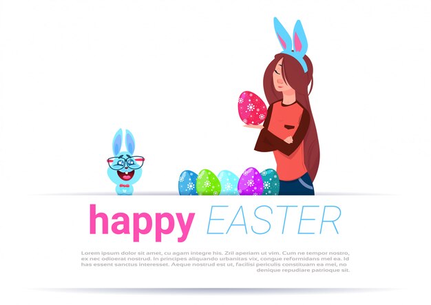 Girl wearing bunny ears paint eggs over happy easter template background with funny rabbit