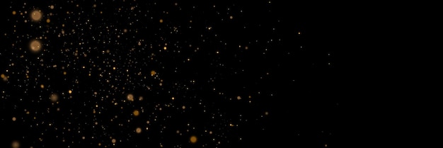 Gloeiend lichteffect in geelgouden kleur met veel glanzende deeltjes geïsoleerd op donkere achtergrond