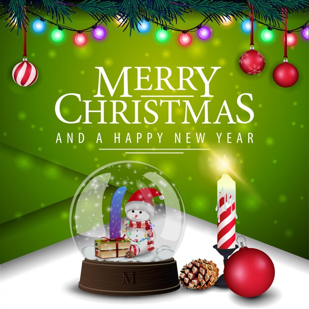Green christmas card with candle and snow globe